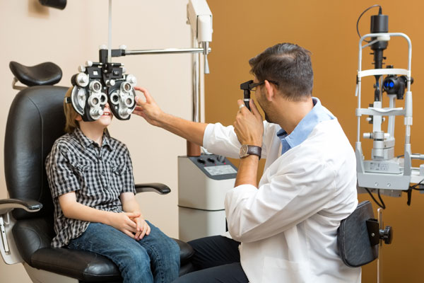 bigstock-Mid-adult-male-optometrist-exa-62275202